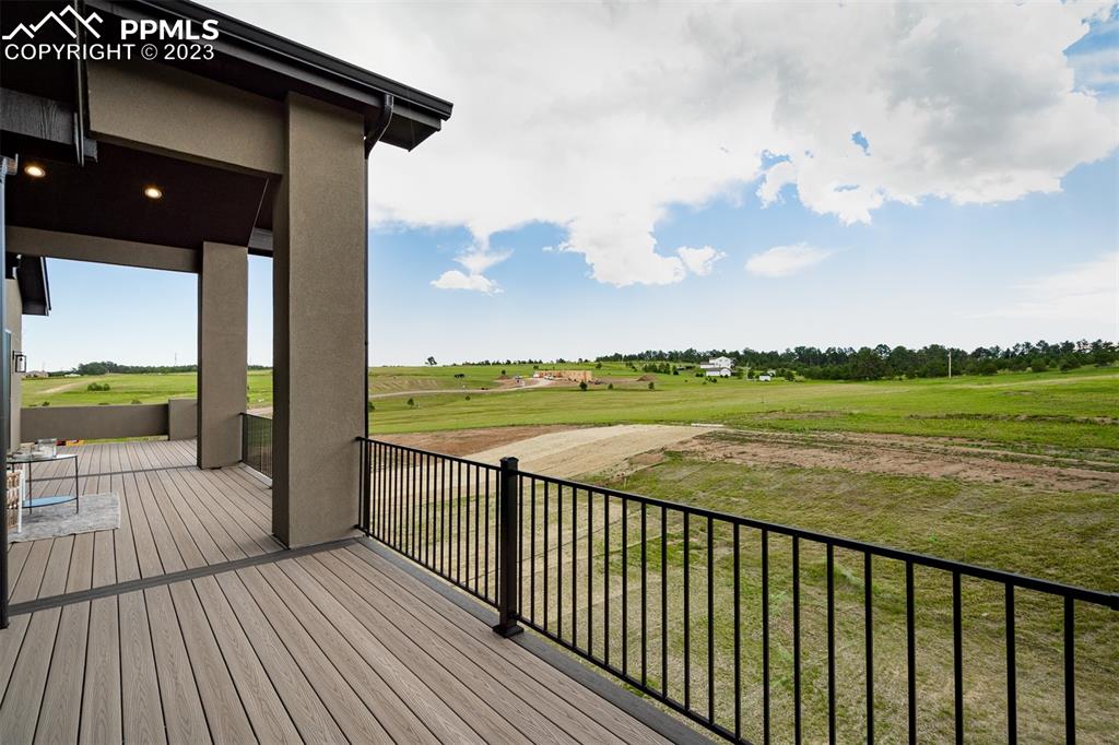 3397 Bark Tree Trail Colorado Springs, CO 80921 - Photo 50 of 50 a view of a balcony with wooden floor & fence