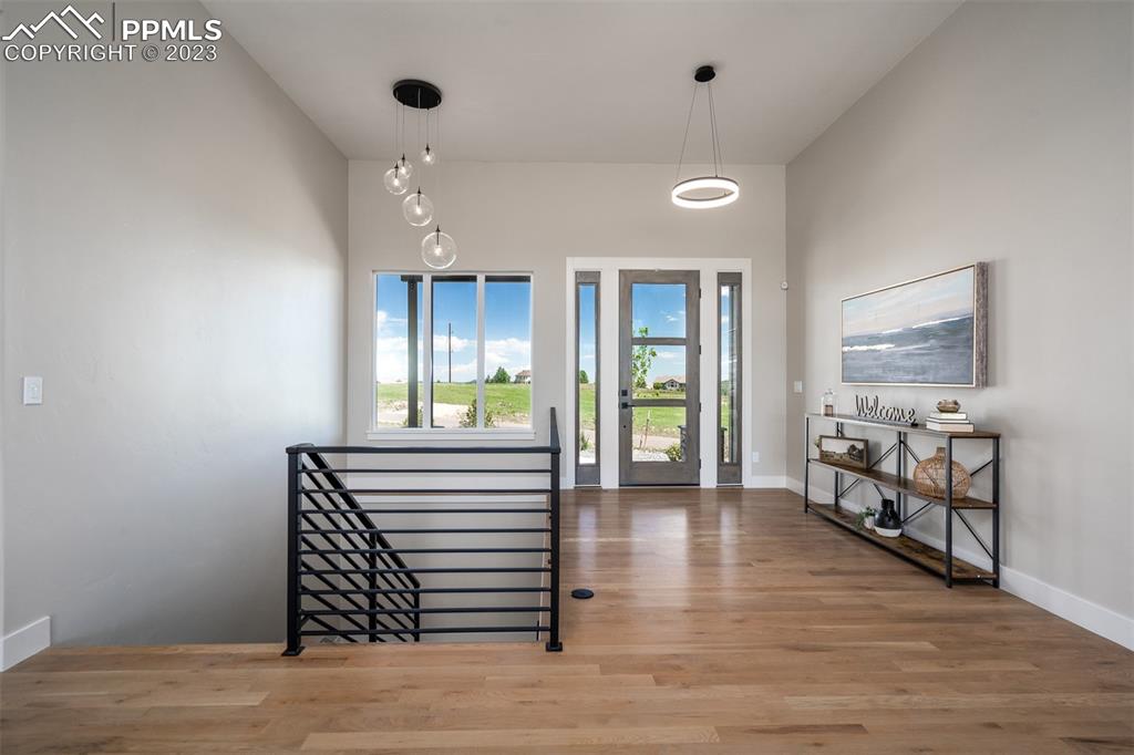 3397 Bark Tree Trail Colorado Springs, CO 80921 - Photo 5 of 50 a view of an entryway with wooden floor and windows