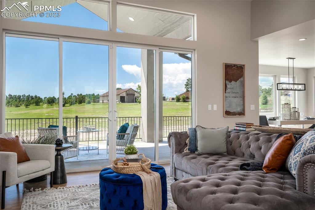 3397 Bark Tree Trail Colorado Springs, CO 80921 - Photo 7 of 50 a living room with furniture and floor to ceiling windows