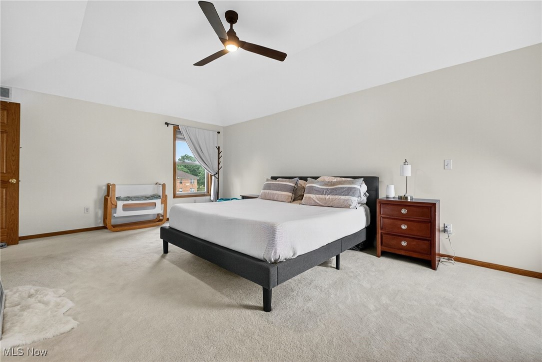 35748 Mills Road Avon, OH 44011 - Photo 21 of 44 Bedroom with light colored carpet, vaulted ceiling, and a ceiling fan