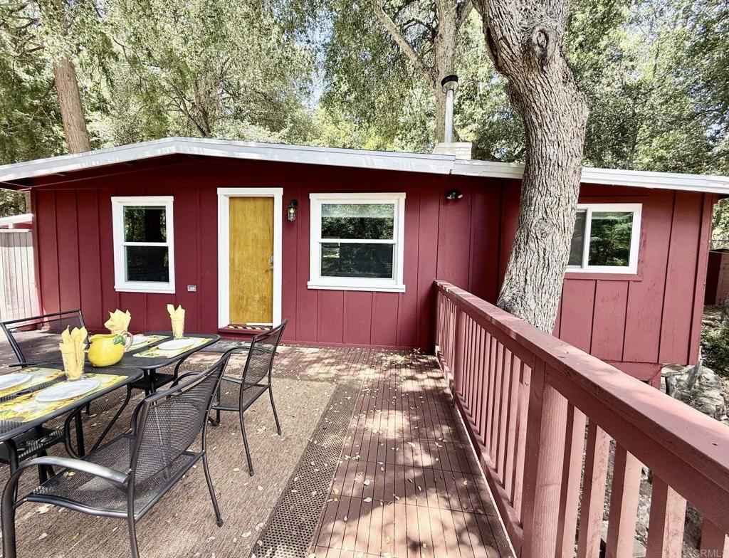 22292 Crestline Road Palomar Mountain, CA 92060 - Photo 14 of 38 a view of a patio with table and chairs and wooden fence