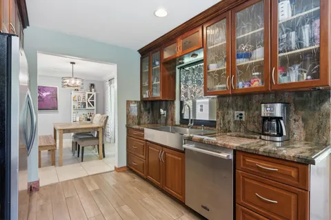 a kitchen with stainless steel appliances granite countertop a stove and cabinets