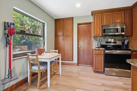 a kitchen with a refrigerator and a stove top oven