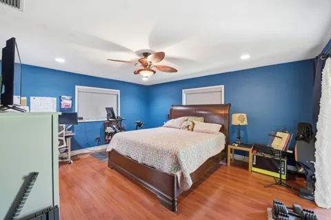 a bedroom with a bed and a chandelier