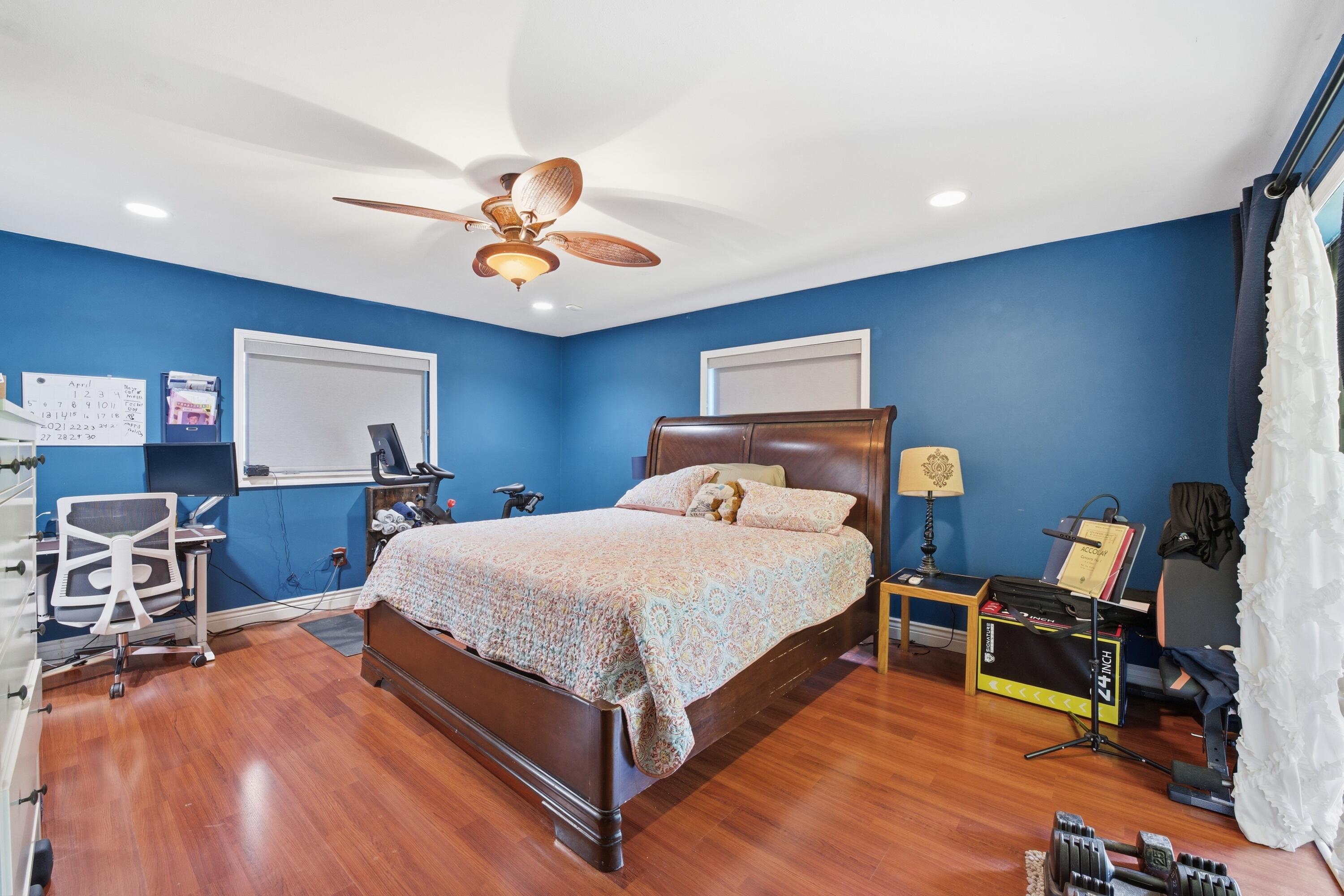22504 Southwest 65th Avenue Boca Raton, FL 33428 - Photo 19 of 36 a bedroom with a bed a table and chair