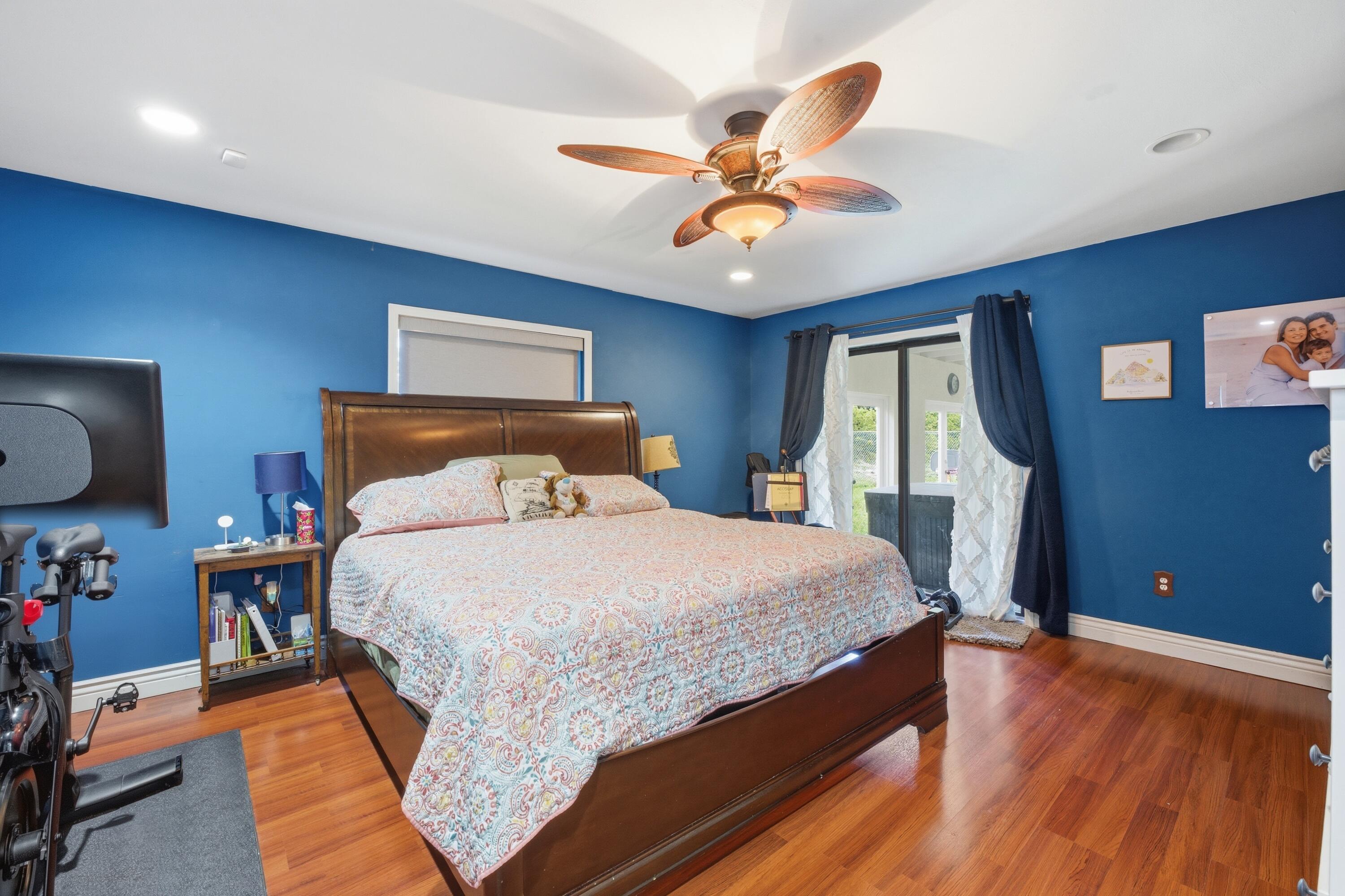 22504 Southwest 65th Avenue Boca Raton, FL 33428 - Photo 20 of 36 a bedroom with a bed and wooden floor