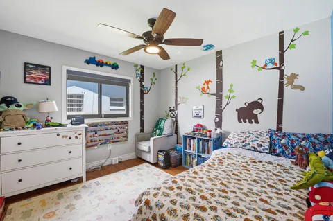 a bedroom with a bed and a dresser in it