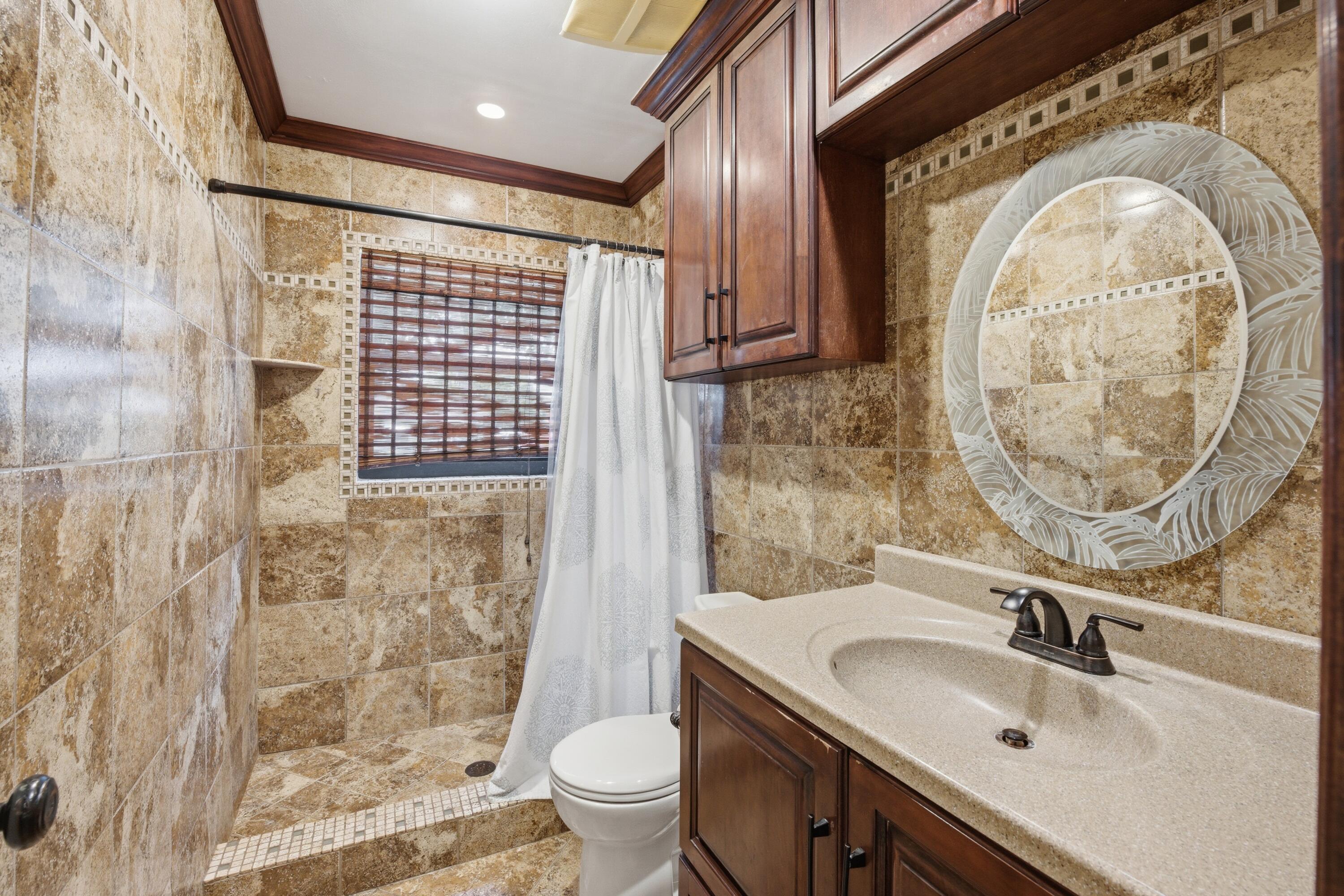 22504 Southwest 65th Avenue Boca Raton, FL 33428 - Photo 24 of 36 a bathroom with a sink a toilet and a shower
