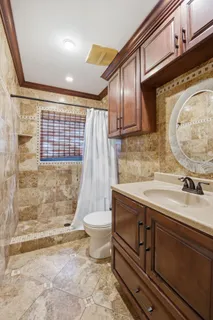 a bathroom with a sink toilet and shower