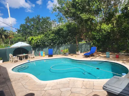 a view of a swimming pool with an outdoor seating