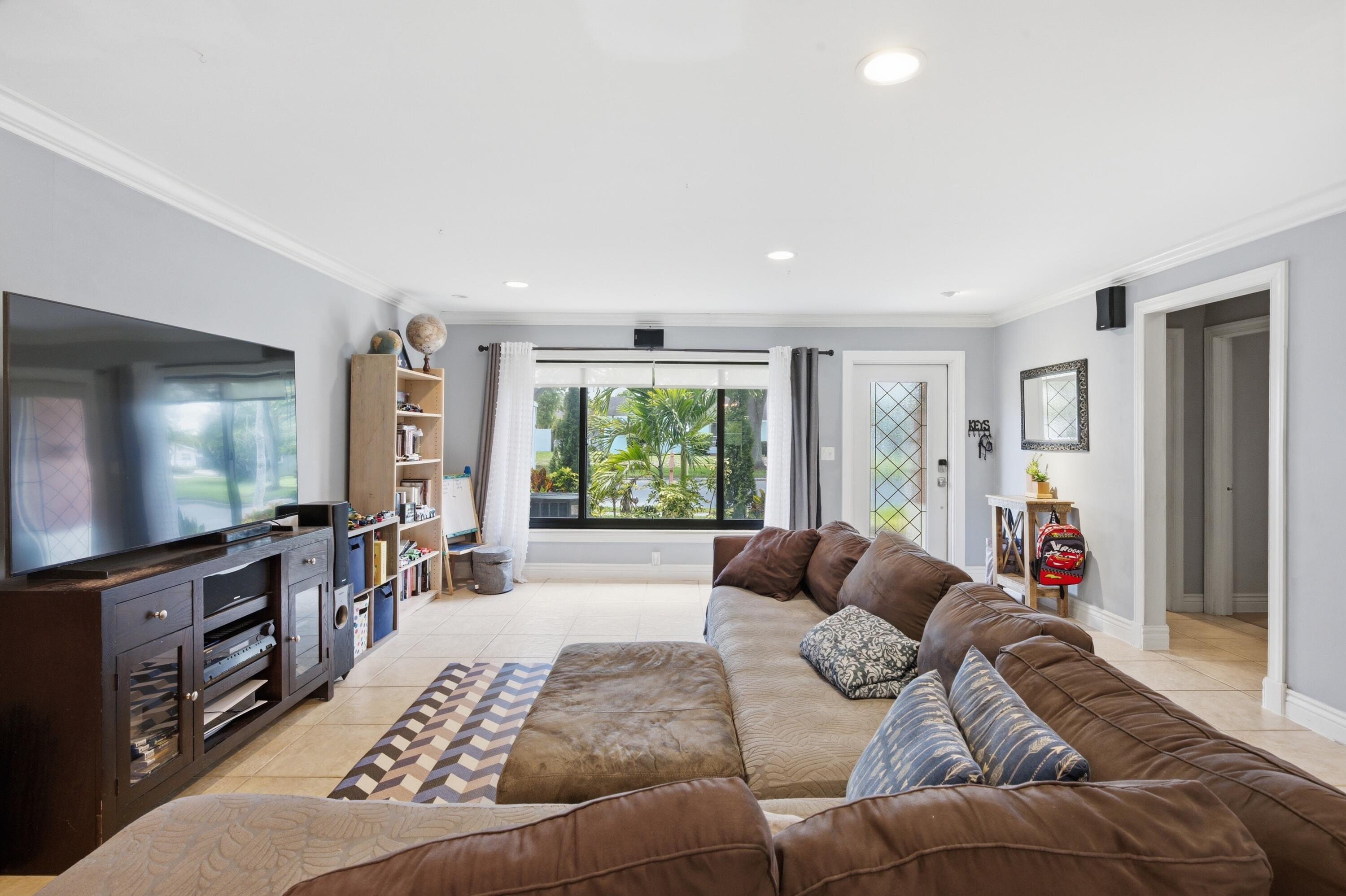 22504 Southwest 65th Avenue Boca Raton, FL 33428 - Photo 3 of 36 a living room with furniture and a flat screen tv