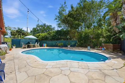 a view of a swimming pool with a lounge chair