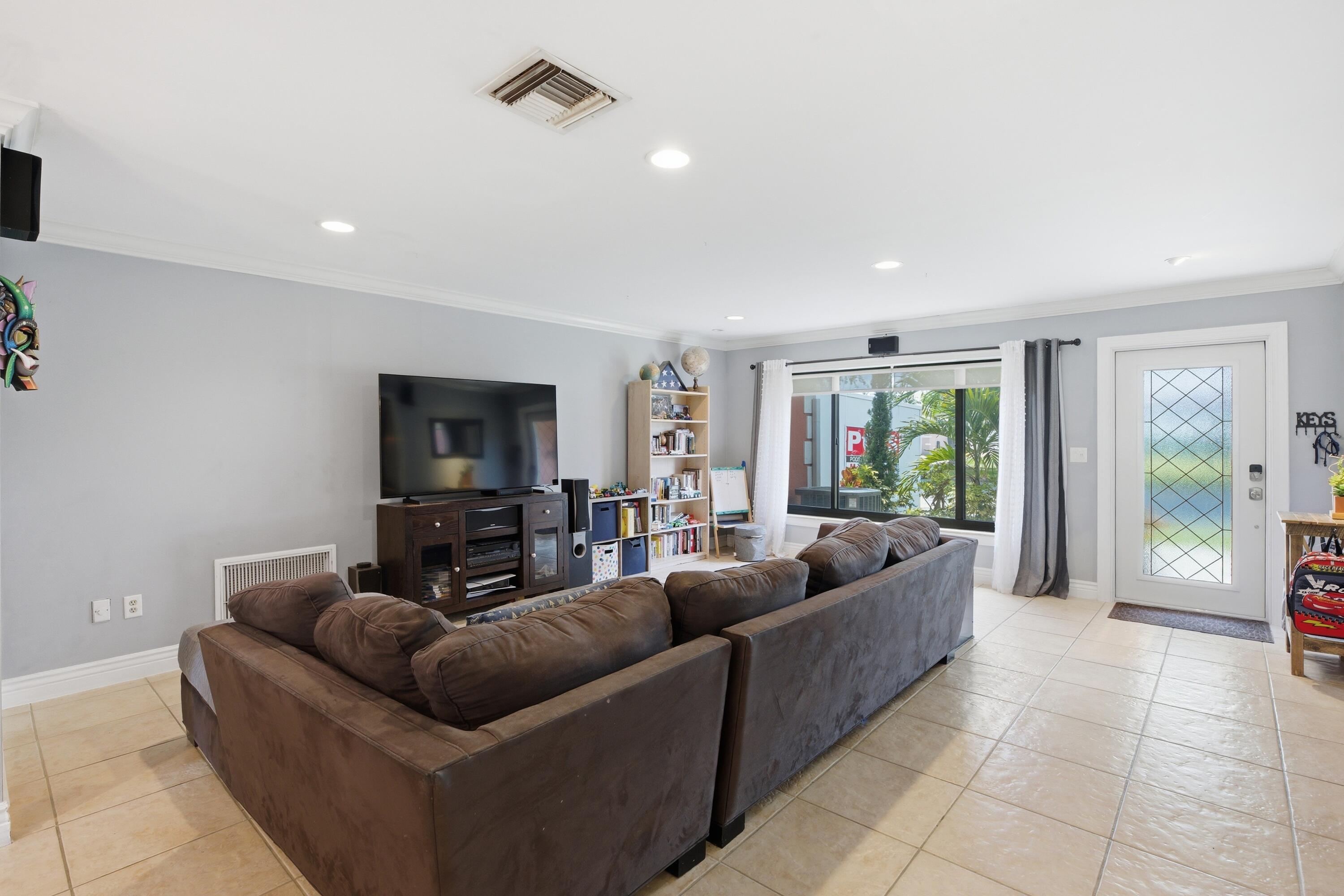 22504 Southwest 65th Avenue Boca Raton, FL 33428 - Photo 4 of 36 a living room with furniture and a flat screen tv