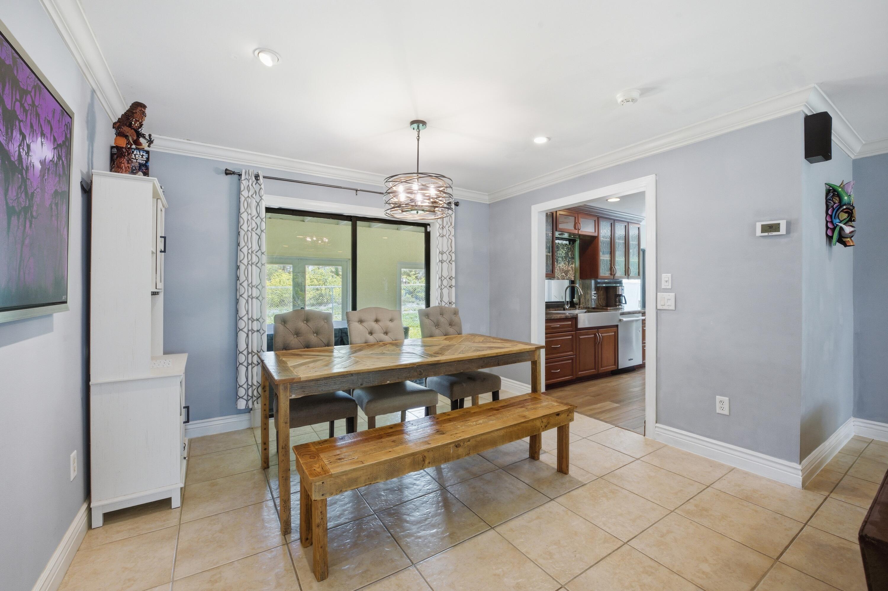 22504 Southwest 65th Avenue Boca Raton, FL 33428 - Photo 8 of 36 a view of a dining room with furniture