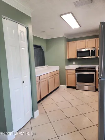 a kitchen with a stove top oven and cabinets