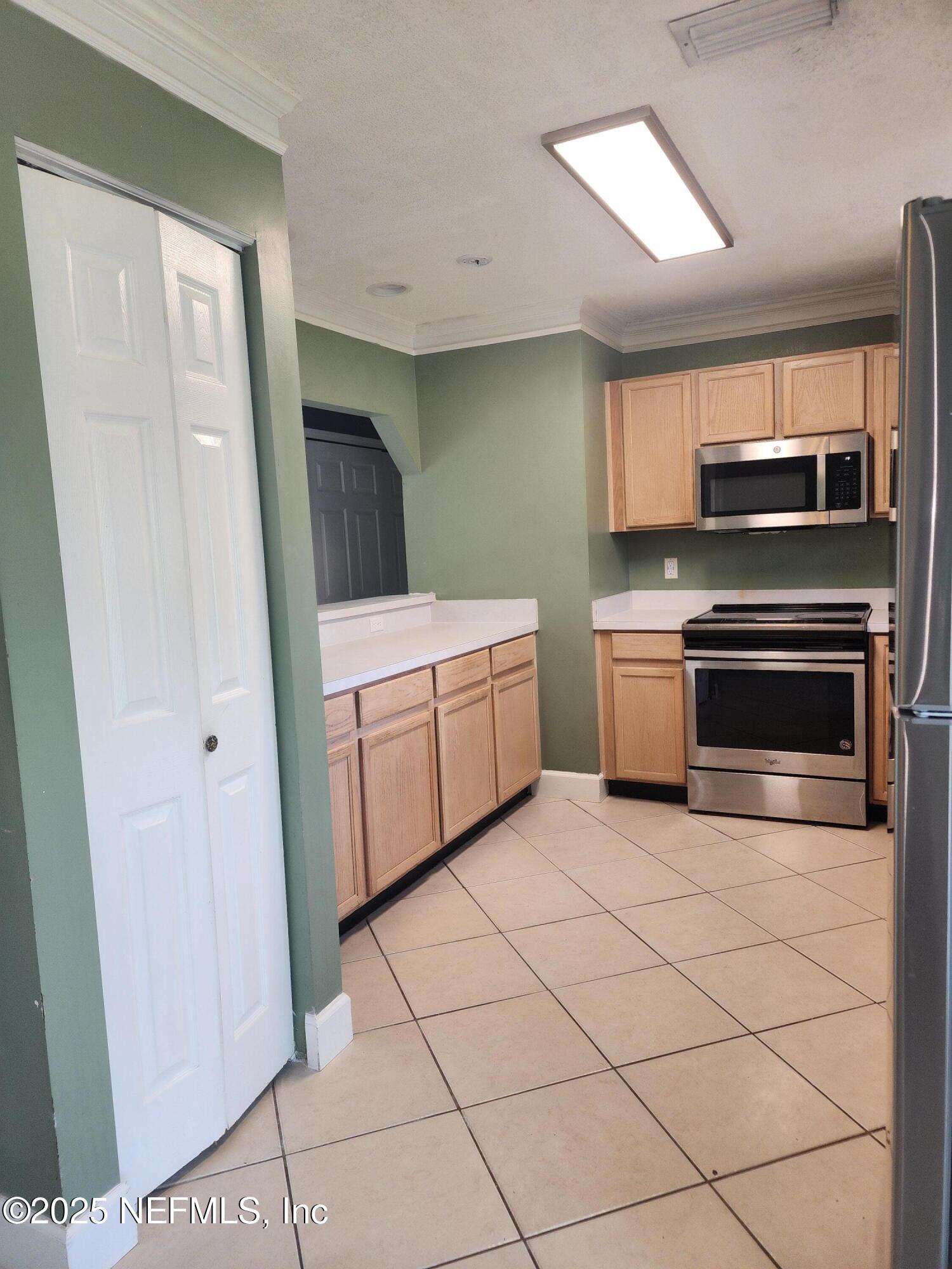 3794 Ron Road Green Cove Springs, FL 32043 - Photo 11 of 34 a kitchen with a stove top oven and cabinets