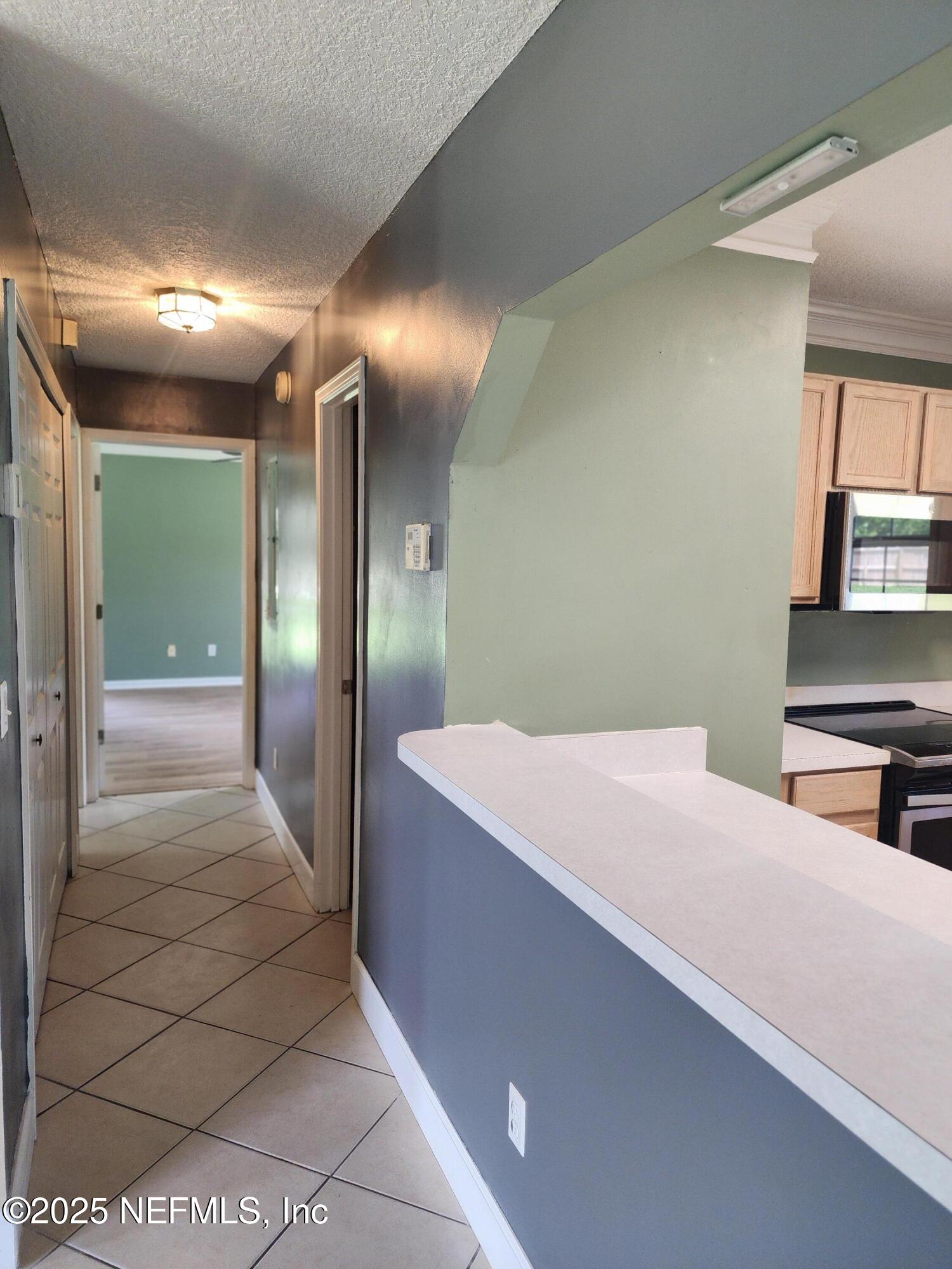 3794 Ron Road Green Cove Springs, FL 32043 - Photo 12 of 34 a hallway with a large mirror