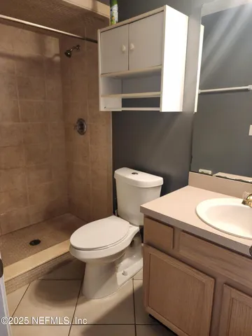 a white toilet sitting next to a bathroom sink