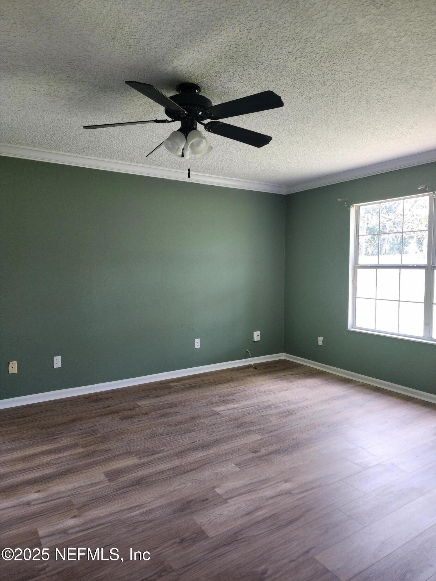 3794 Ron Road Green Cove Springs, FL 32043 - Photo 15 of 34 an empty room with wooden floor and windows