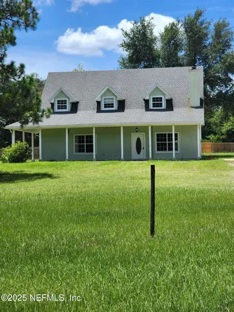 a view of a house with a backyard