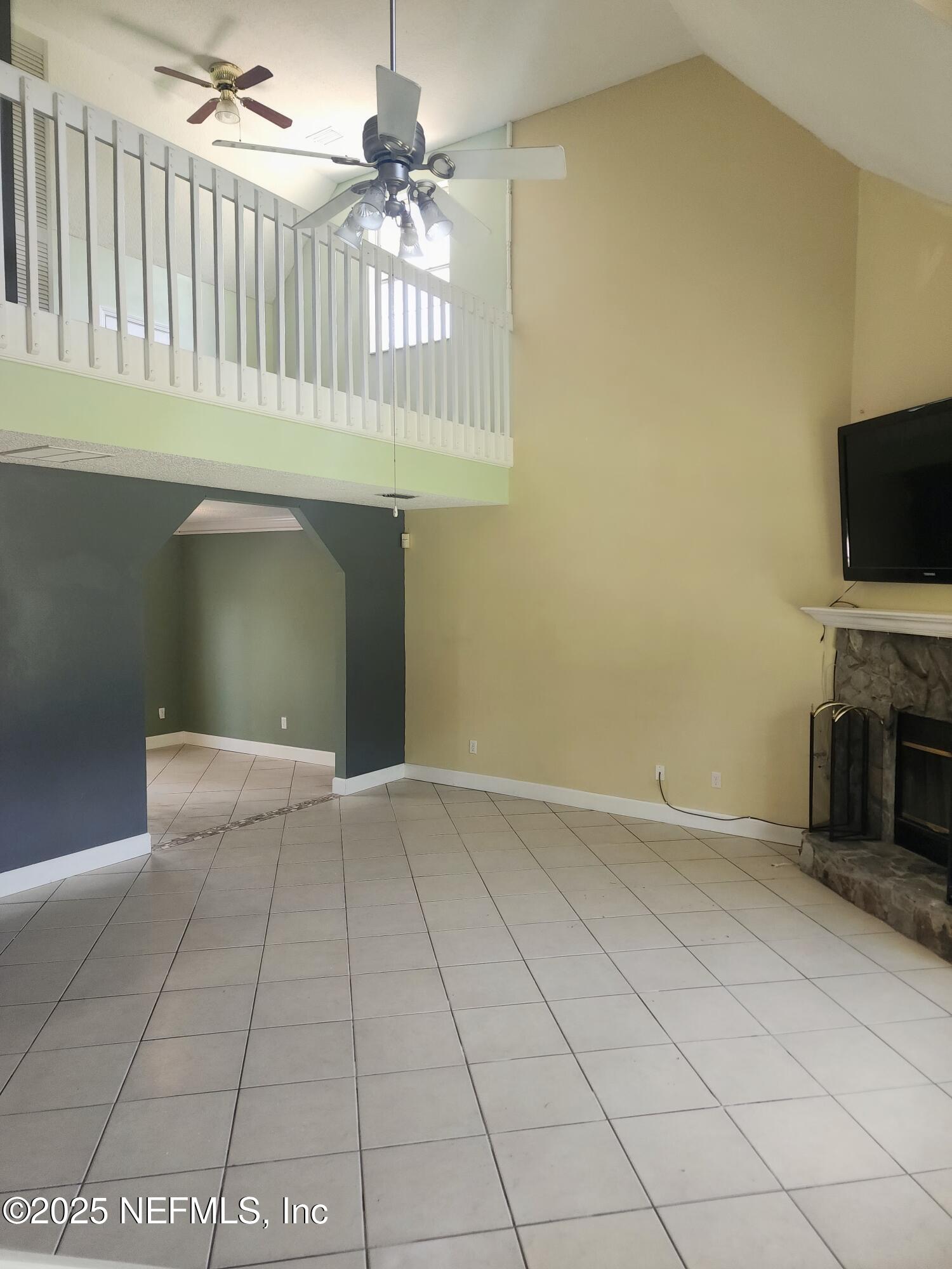 3794 Ron Road Green Cove Springs, FL 32043 - Photo 4 of 34 a view of an empty room with a fireplace and a window