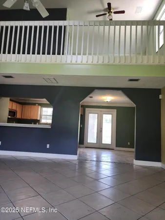 a view of gallery with wooden floor