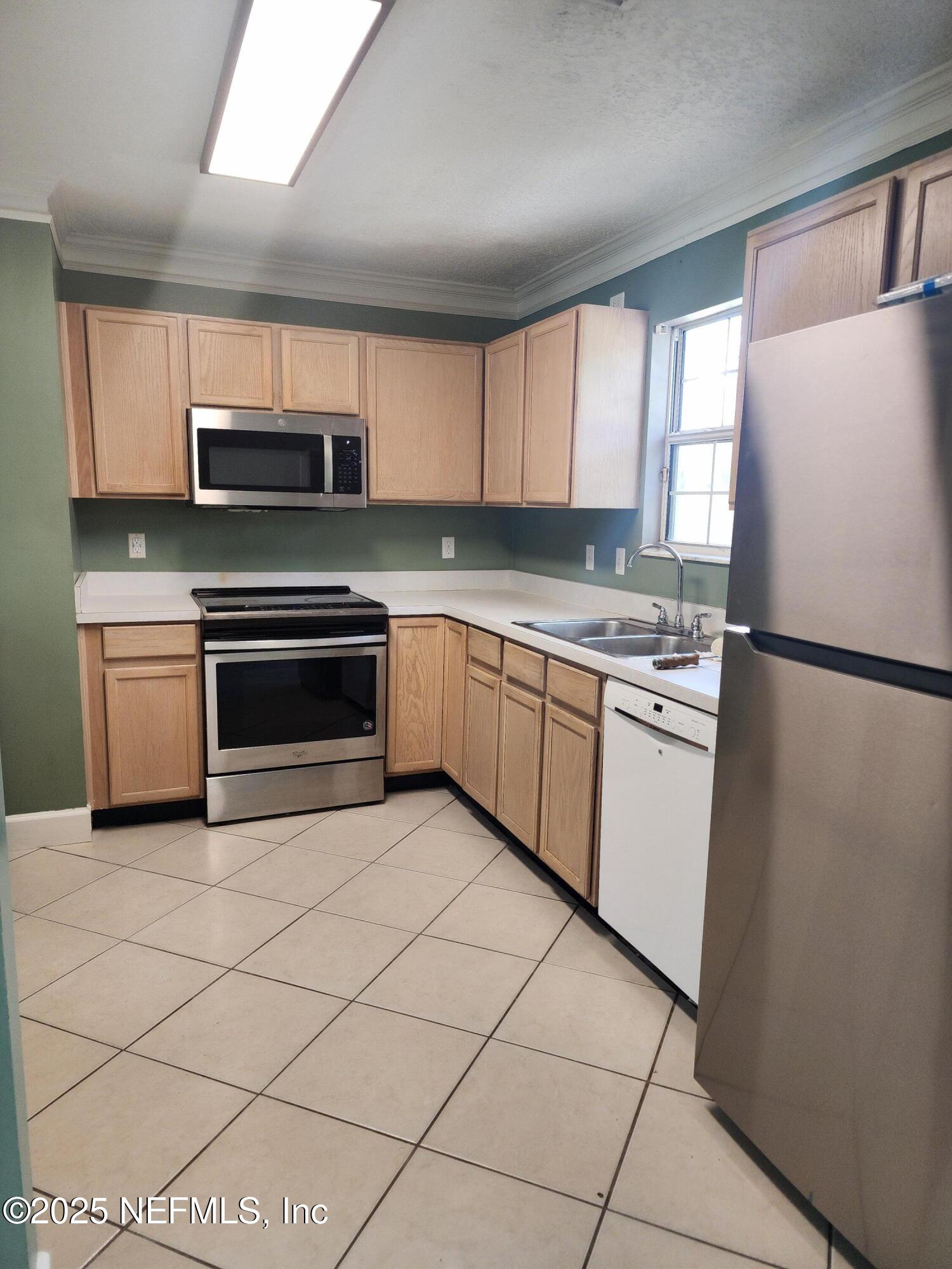 3794 Ron Road Green Cove Springs, FL 32043 - Photo 10 of 34 a kitchen with stainless steel appliances granite countertop a stove a sink and a refrigerator