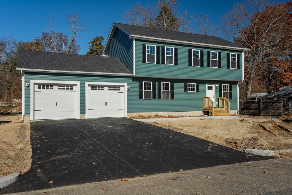 16 Cornflower Street Springfield, MA 01118 - Photo 1 of 36 a front view of a house with a yard and garage