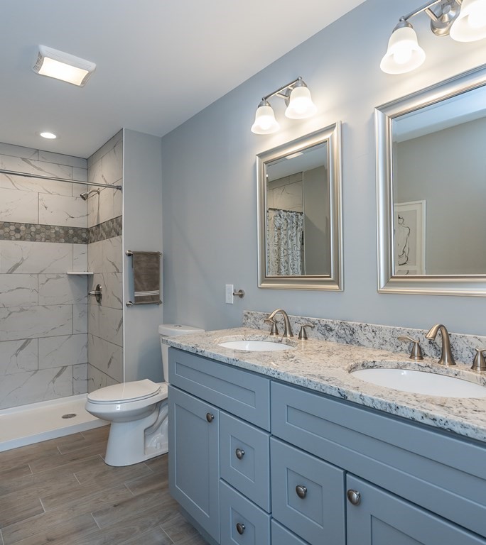 16 Cornflower Street Springfield, MA 01118 - Photo 25 of 36 a bathroom with a granite countertop toilet sink and mirror