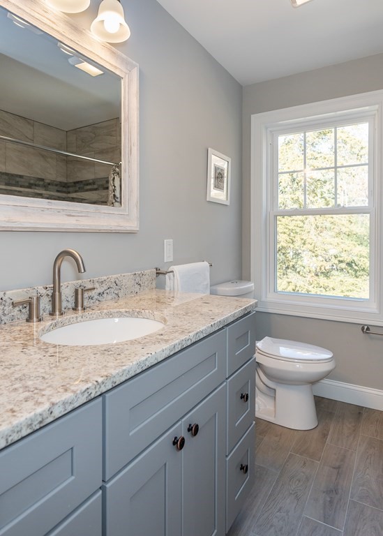 16 Cornflower Street Springfield, MA 01118 - Photo 34 of 36 a bathroom with a granite countertop sink a toilet and a window