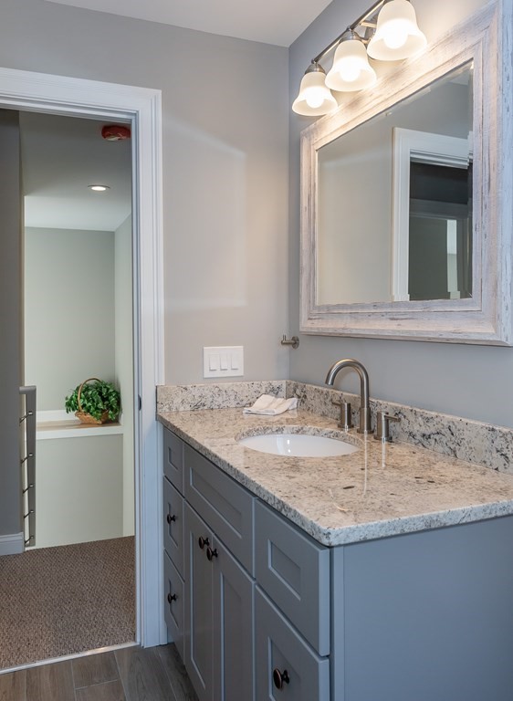 16 Cornflower Street Springfield, MA 01118 - Photo 36 of 36 a bathroom with a granite countertop sink and a mirror