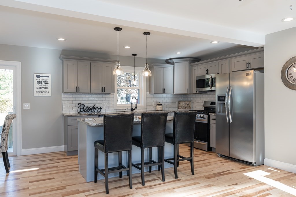 16 Cornflower Street Springfield, MA 01118 - Photo 8 of 36 a kitchen with granite countertop a refrigerator and a stove top oven