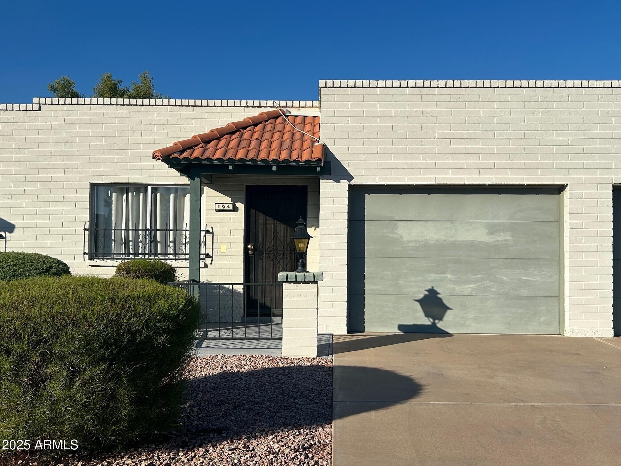 4328 East Capri Avenue, Unit 194 Mesa, AZ 85206 - Photo 1 of 13 a view of a house with wooden fence