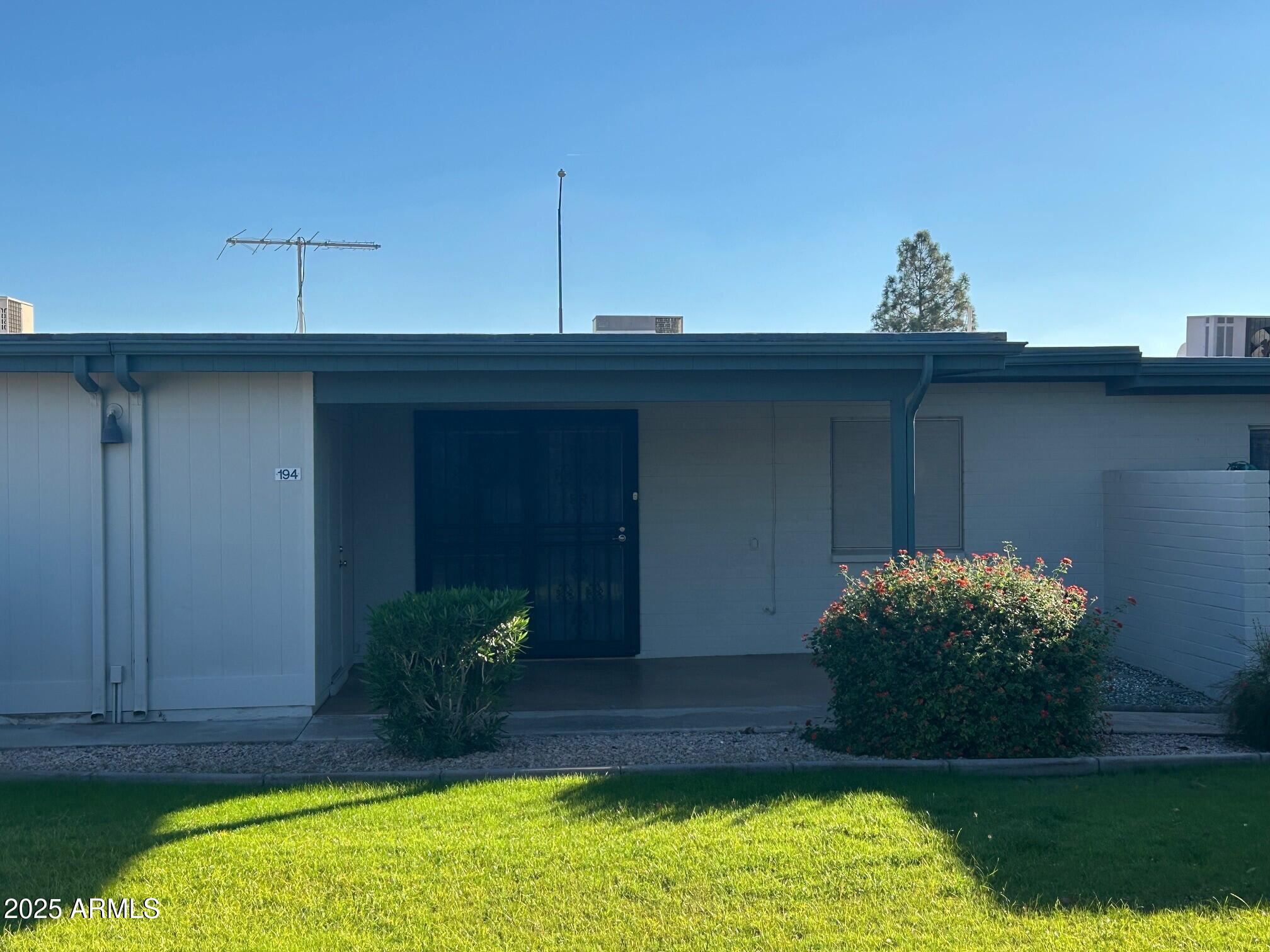 4328 East Capri Avenue, Unit 194 Mesa, AZ 85206 - Photo 13 of 13 a view of a backyard with potted plants and large tree