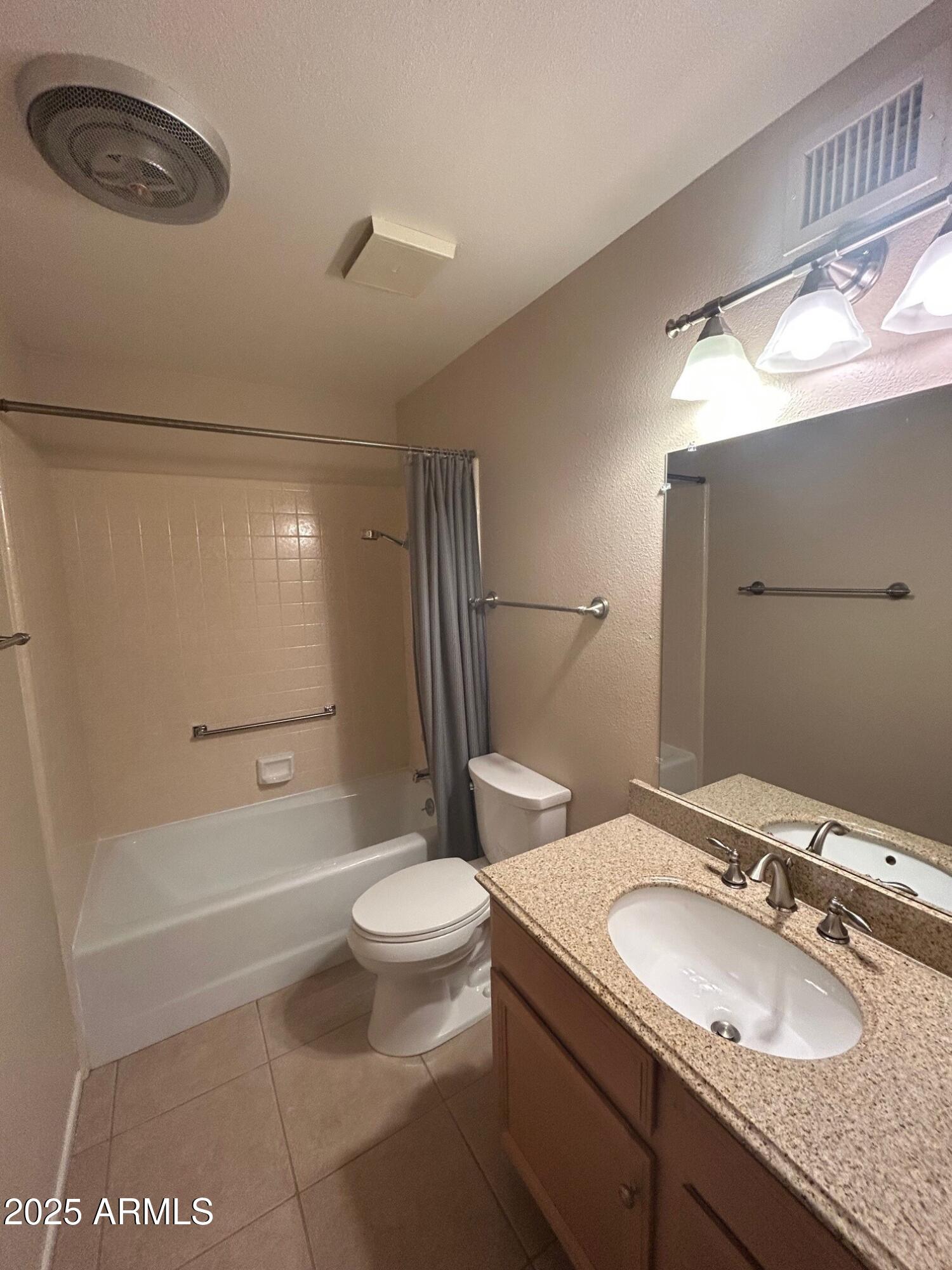 4328 East Capri Avenue, Unit 194 Mesa, AZ 85206 - Photo 3 of 13 a bathroom with a granite countertop sink a toilet a mirror and shower