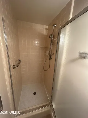 a bathroom with a glass shower door