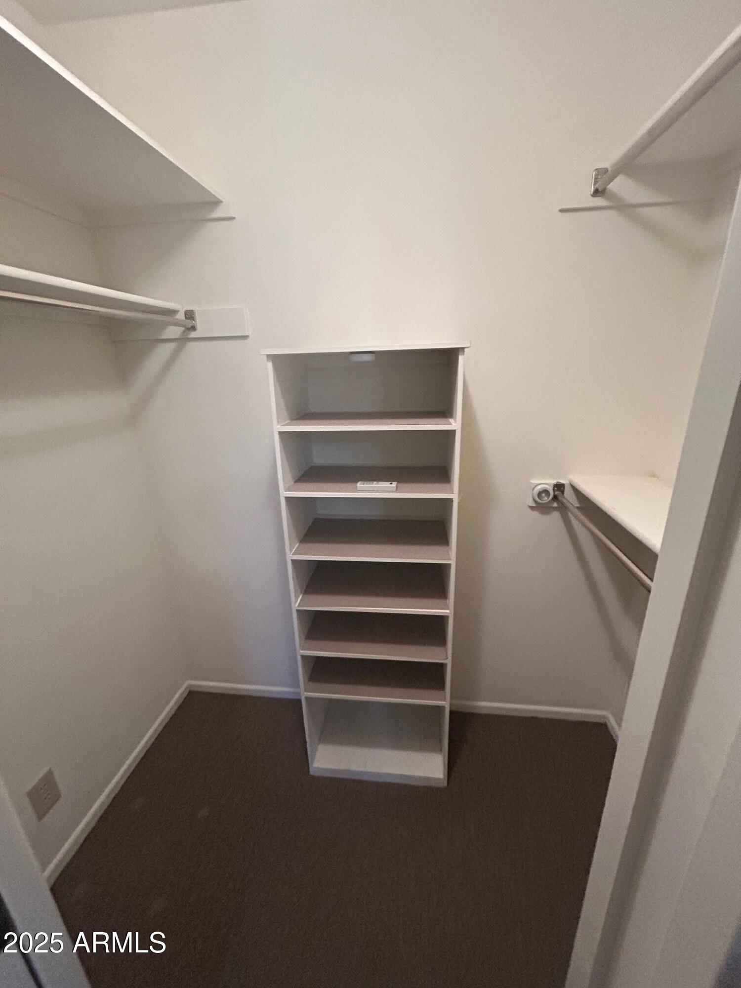 4328 East Capri Avenue, Unit 194 Mesa, AZ 85206 - Photo 8 of 13 a view of walk in closet with empty racks