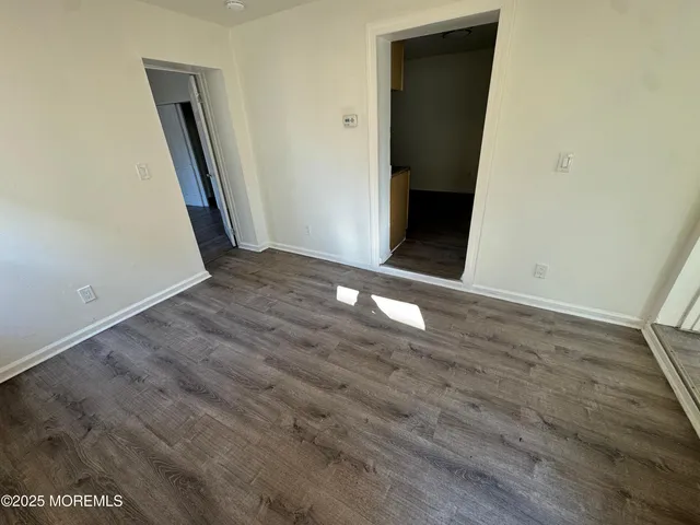 an empty room with wooden floor