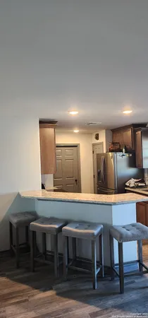 a large kitchen with a table and chairs in it