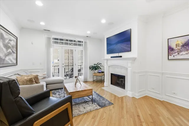 a living room with furniture a fireplace and a flat screen tv