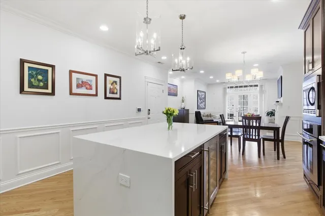 a view of a dining room with furniture and chandelier