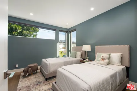 a bedroom with a bed and a potted plant