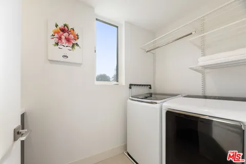a living room kitchen with furniture and a wooden floor
