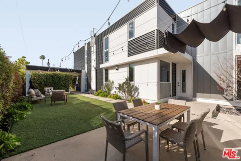 a view of a patio with table and chairs and potted plants