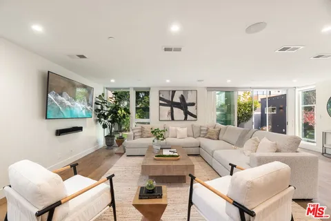 a dining room with furniture and wooden floor