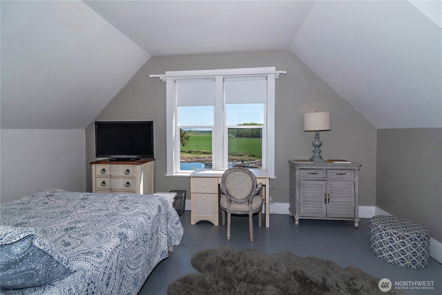 4441 Dry Creek Road Ellensburg, WA 98926 - Photo 27 of 32 a bedroom with furniture and a flat screen tv