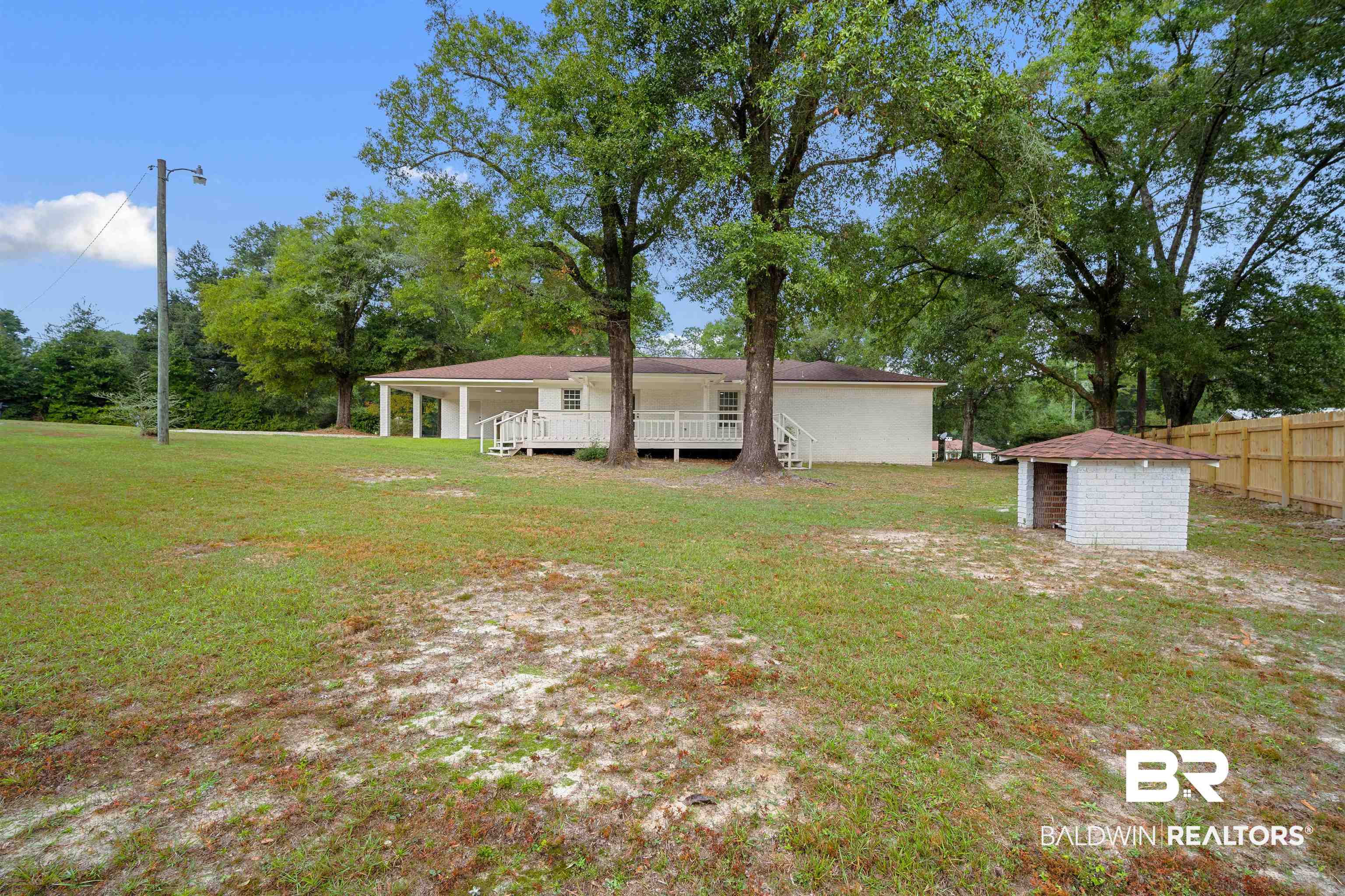 3050 Lacoste Road Mobile, AL 36618 - Photo 29 of 30 Rear view of property featuring a lawn and an outbuilding