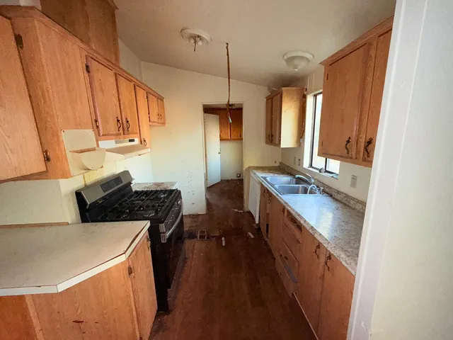 a kitchen with a sink stove and refrigerator