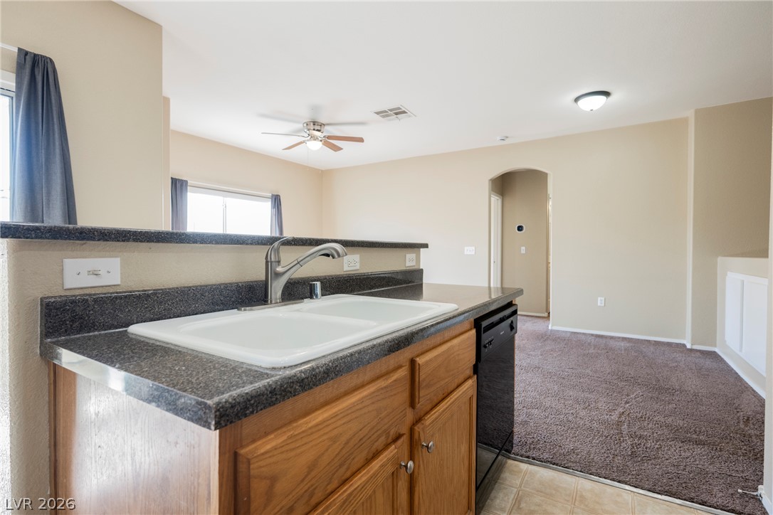 6320 Snap Ridge Street, Unit 201 North Las Vegas, NV 89081 - Photo 25 of 56 A functional kitchen space offers a breakfast bar and essential appliances for easy living.