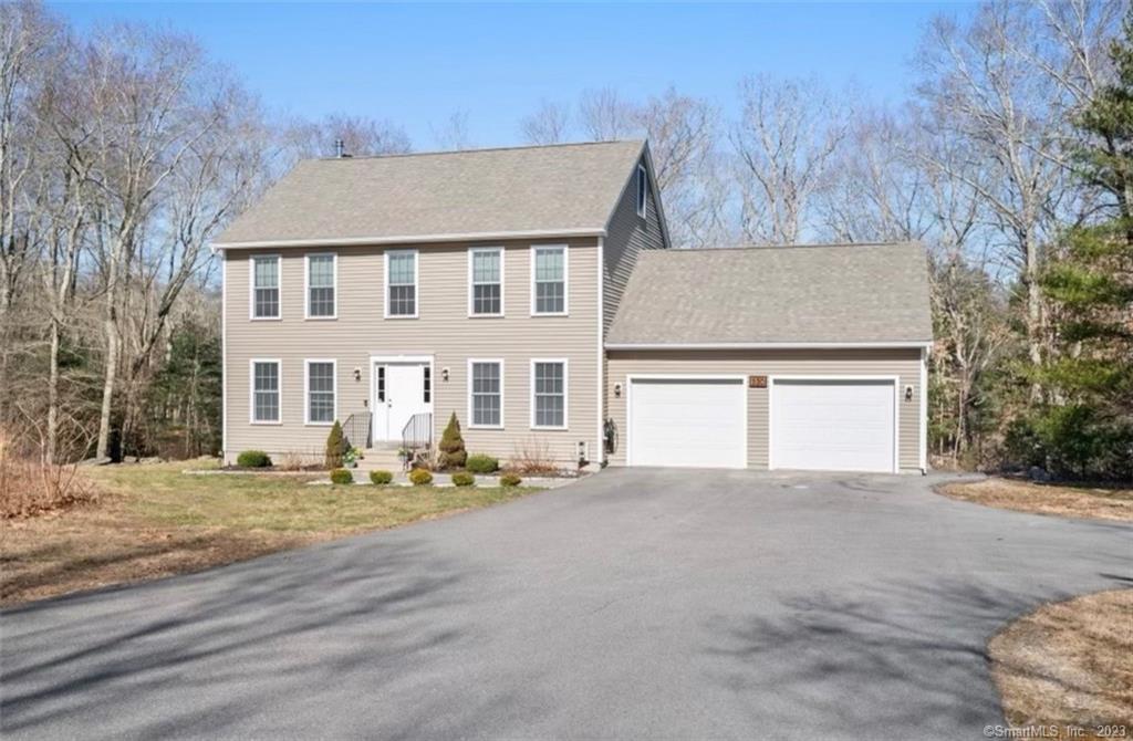 a front view of a house with a yard and garage